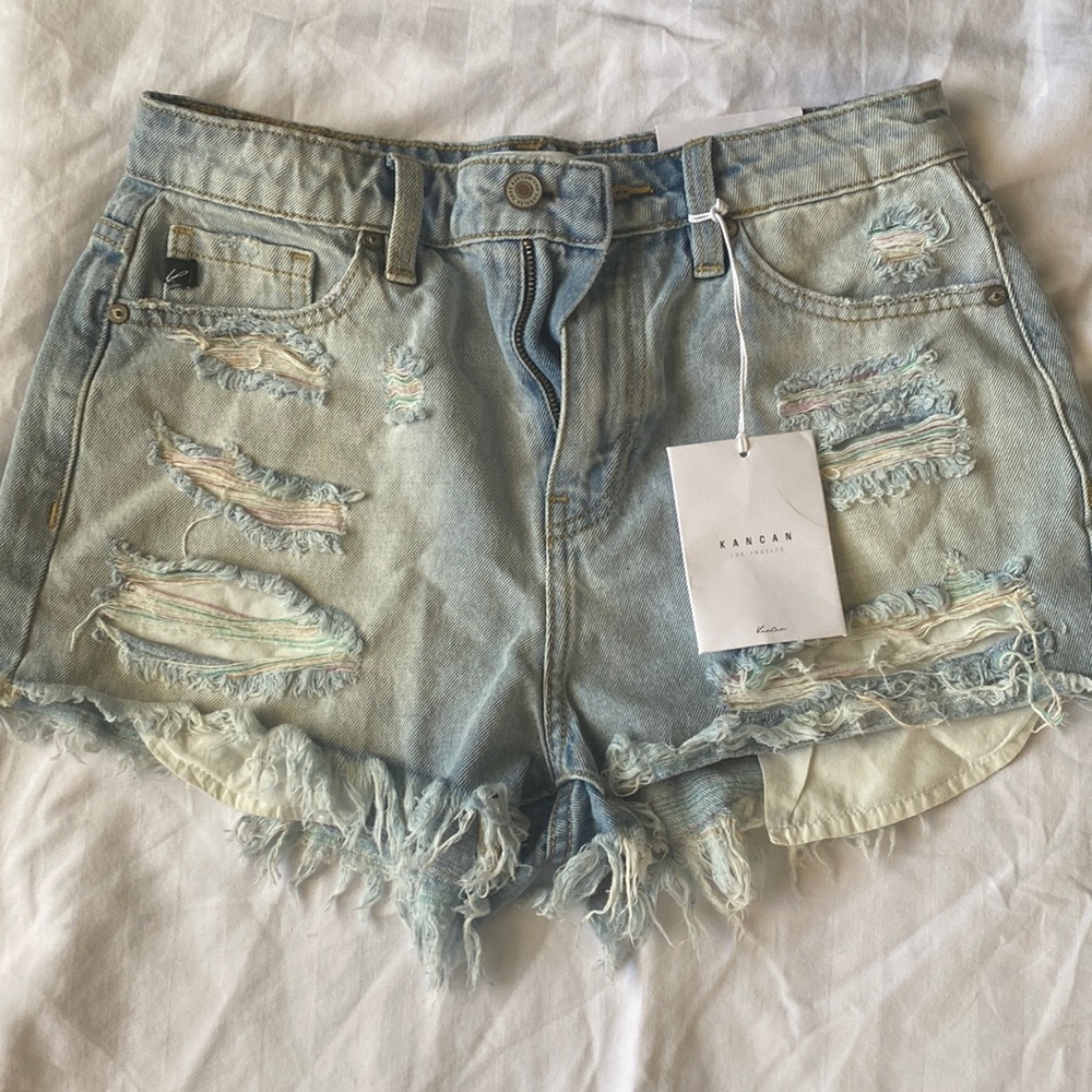 Hi rise denim shorts with some pastel coloring in the distress